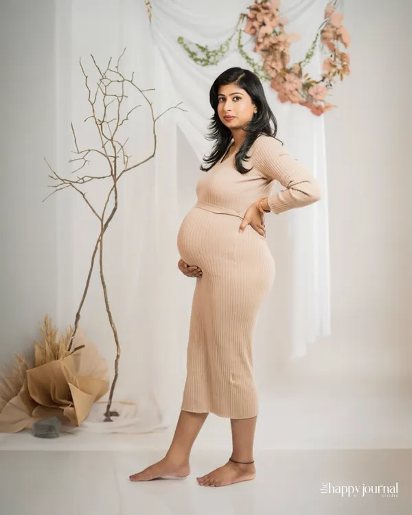 A simple, elegant portrait in a comfortable ribbed dress. The neutral tones and minimalist set design create a modern and timeless look that focuses on the beauty of the mother-to-be.