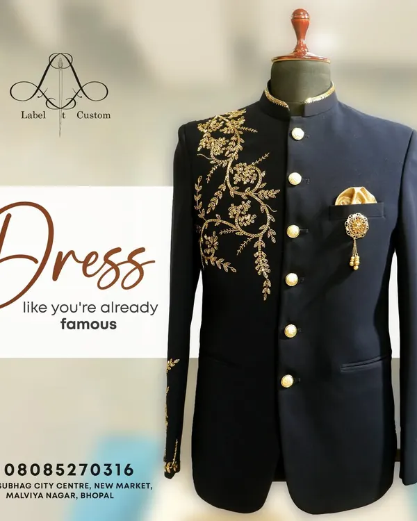 Dress like you're already famous. This navy blue Jodhpuri suit with elegant gold floral embroidery on the shoulder and cuff is designed to make a powerful statement. It's a perfect example of my bespoke ethnic wear for grooms.