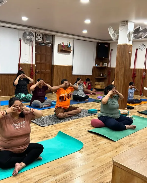 A group of students practicing Brahmari Pranayama, or the Humming Bee Breath. This calming technique uses sound vibration to soothe the nervous system, reduce stress, and quiet the mind.