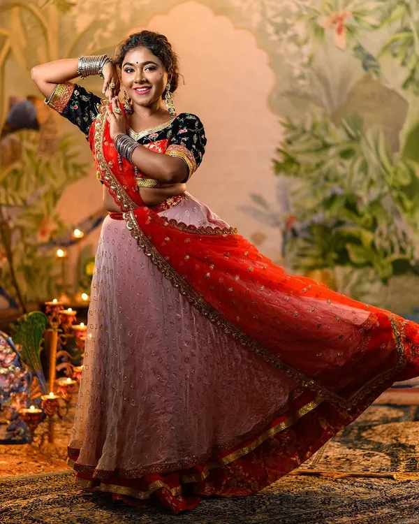 Our recreation of Deepika Padukone's iconic 'Ram Leela' lehenga, captured in a dynamic pose that shows the beautiful flare of the skirt. The red dupatta adds a striking contrast to the black embroidered choli.