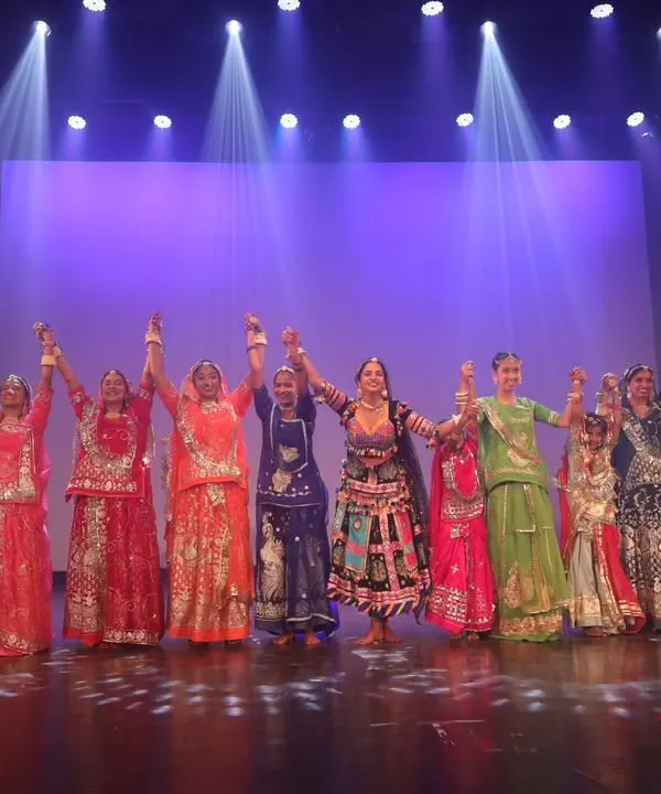 The final bow after a grand stage performance. This moment of unity with all the dancers holding hands captures the spirit of teamwork in our group choreographies.