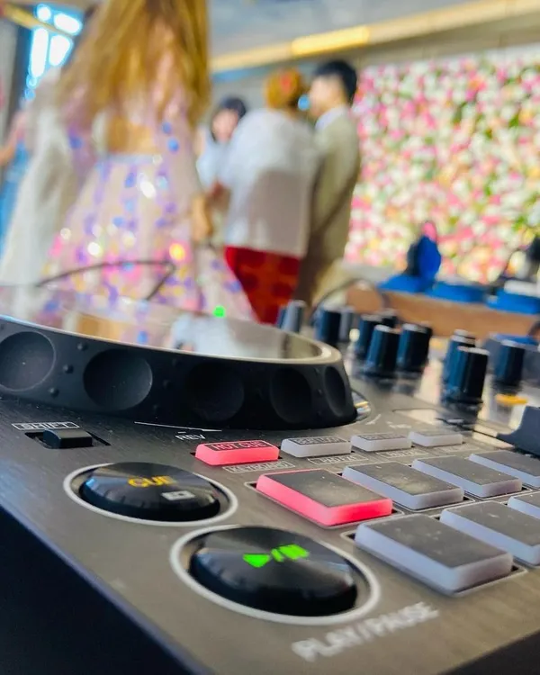 A close-up of my Pioneer DJ controller, the heart of my setup. The cue and play buttons are ready for action at a wedding party.