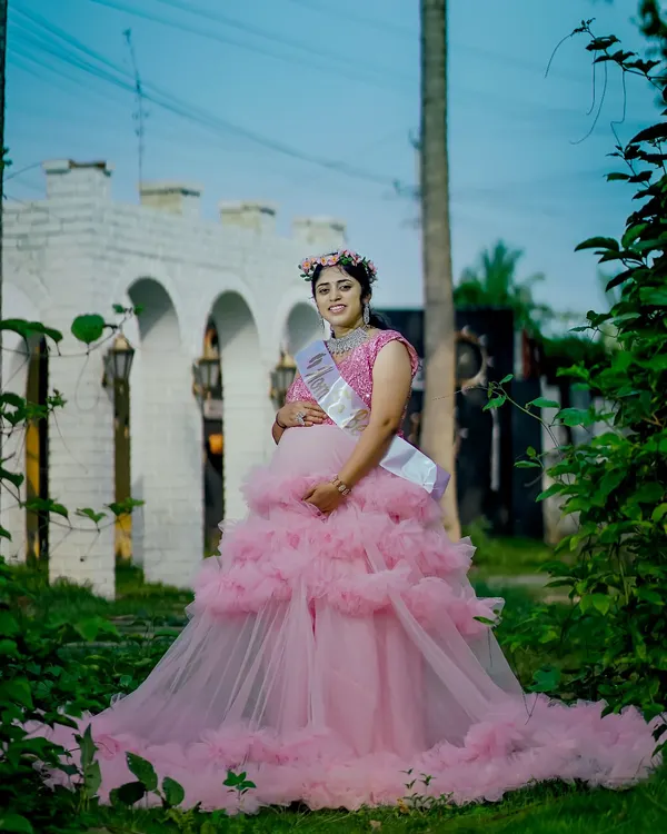 A full-length view of our pink ruffle gown, perfect for a baby shower or maternity shoot. The layered ruffles create a beautiful, full skirt that looks stunning in photos.