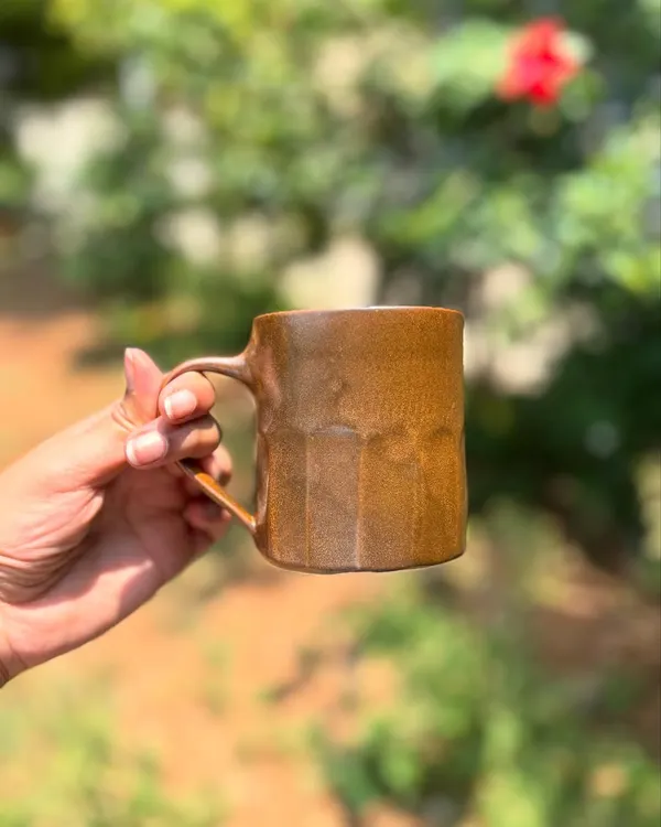 Our Languid Magic glaze is truly unpredictable. This faceted mug shows off the warm, wood-brown tones that can result from the firing.