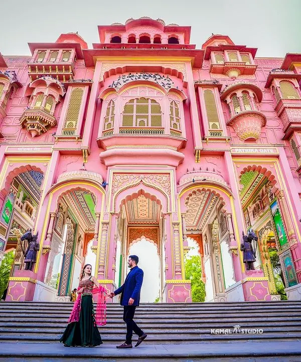 A breathtaking wide shot at the Patrika Gate in Jaipur. The grand scale and vibrant colors of the architecture make for an unforgettable, magazine-worthy pre-wedding photograph.
