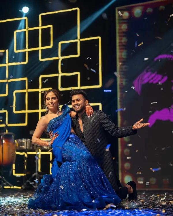 A Sangeet night is incomplete without an epic couple's performance. This shot, with confetti raining down, captures the energy and romance of their dance.