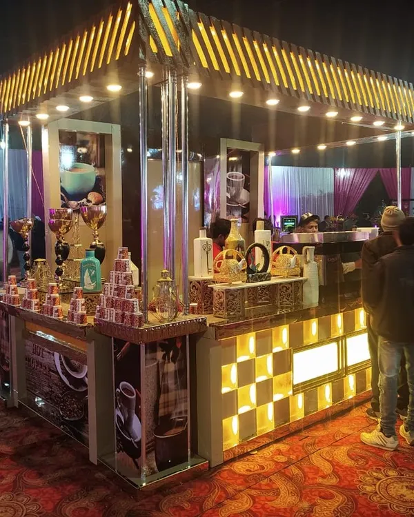 This is a full-scale, standalone coffee kiosk I provided for a large outdoor wedding. The 'V. Café Coffee' station is fully branded and lit, featuring professional espresso machines and baristas ready to serve guests.