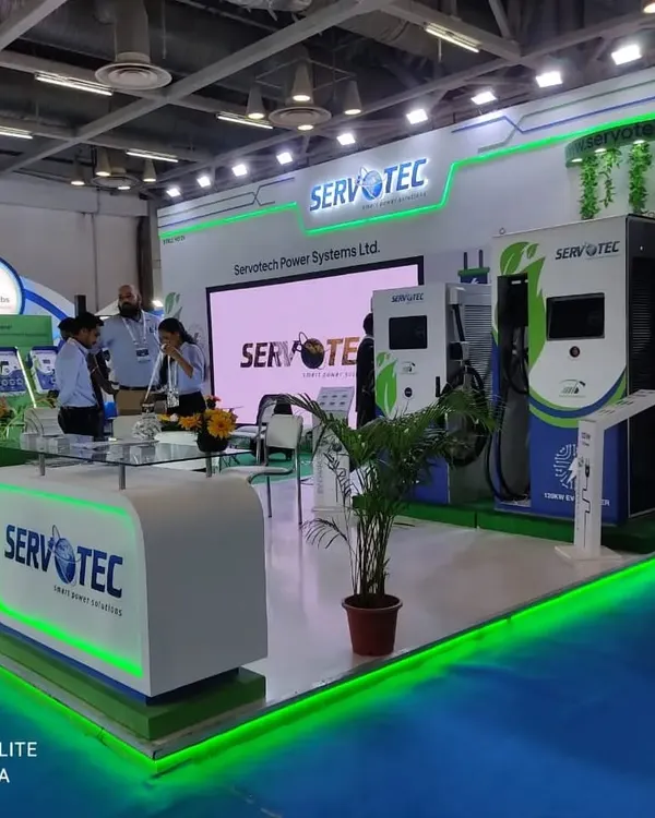 A vibrant and well-lit exhibition stall for Servotec. The use of brand colors, LED lighting, and clear signage helps attract visitors from across the hall.
