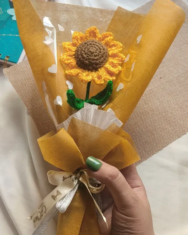 A single crochet sunflower, beautifully wrapped and ready to brighten someone's day. We pay attention to every detail, down to the branded ribbon.
