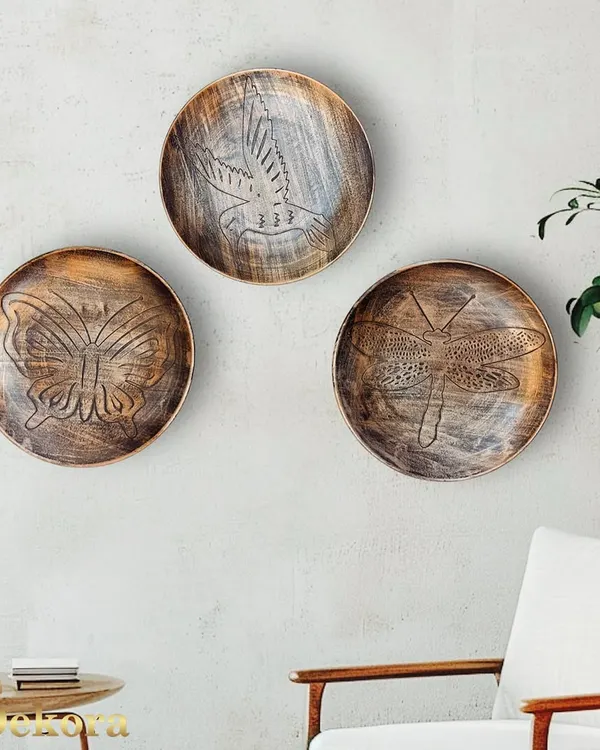 This set of three decorative metal plates features beautifully etched nature designs: a bird, a butterfly, and a dragonfly. The rustic, weathered finish gives them a timeless, artisanal quality.