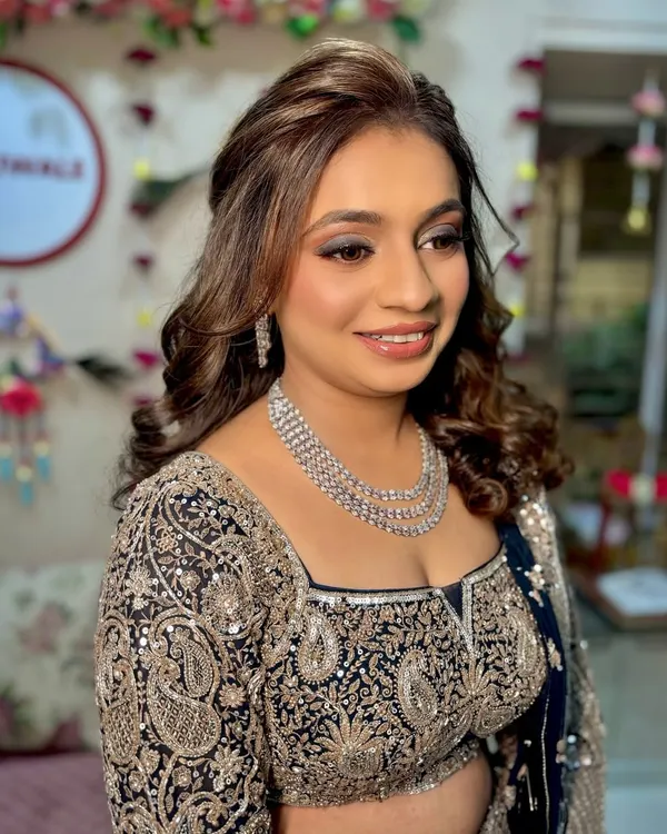 A glamorous sangeet look featuring shimmery eyeshadow and glossy lips, perfect for a night of celebration.