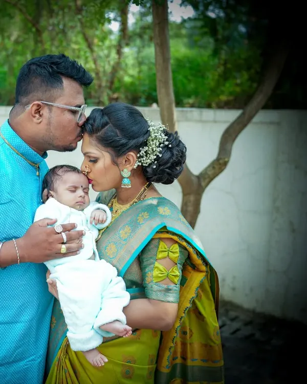 A tender moment between new parents and their baby. Kisses from mom and dad make for the most precious family portraits.