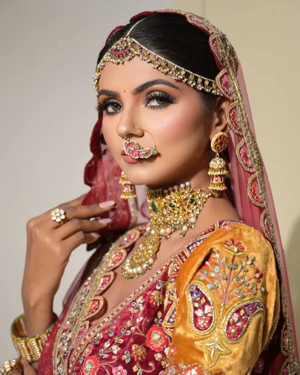 A close-up from a styled bridal shoot, showcasing a dramatic and regal look. The smokey eye, flawless contour, and intricate jewelry come together to create a breathtaking vision of bridal beauty.