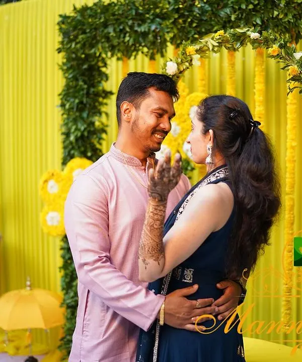A happy couple shares a moment during their Haldi ceremony. We created a vibrant yellow backdrop with marigold floral arrangements to match the joyous and energetic spirit of the event.