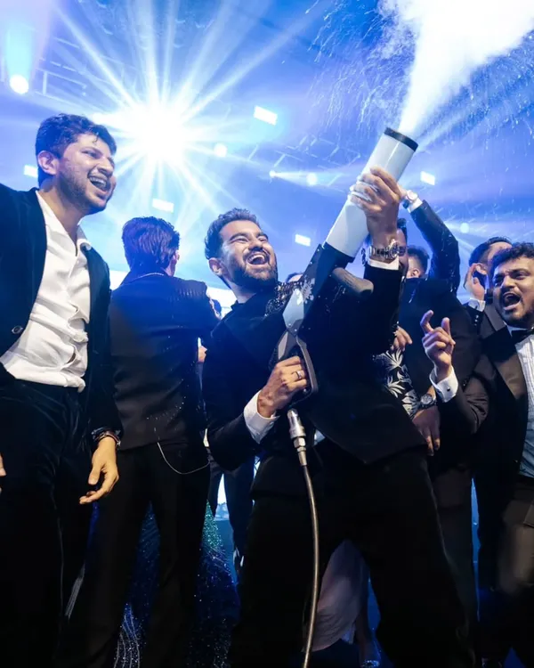 The groom and his friends having a blast with a CO2 gun on the dance floor.