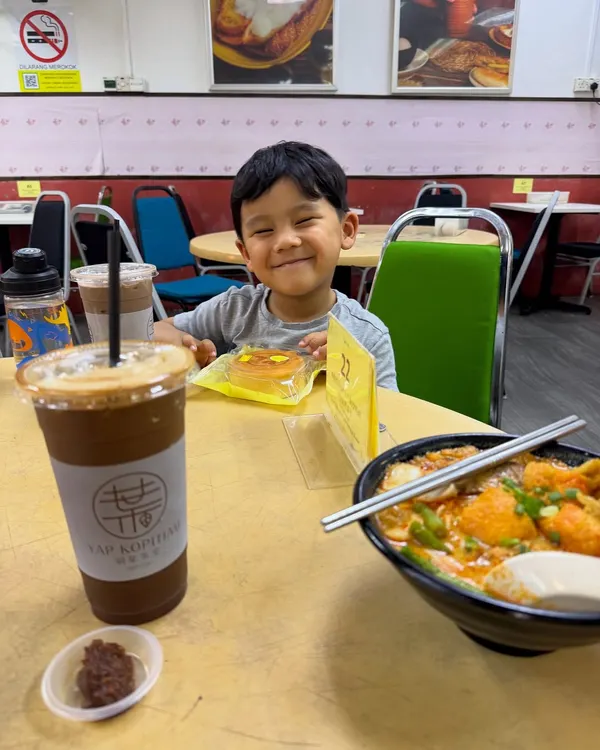 My son Zev enjoying a snack at a kopitiam in Kuala Lumpur. His happy smile is everything. These are the simple, cherished moments and food memories I hope he carries with him forever.