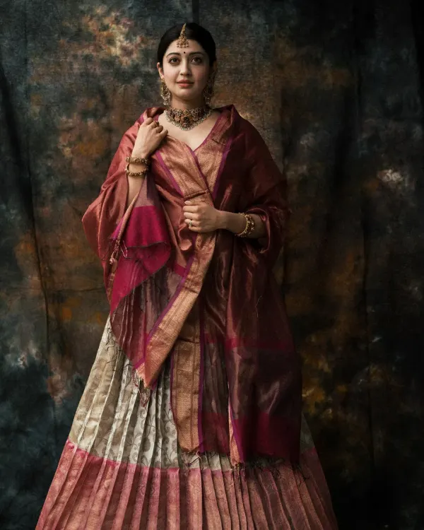 A royal portrait featuring a stunning traditional lehenga. I used a painterly backdrop and soft lighting to create a timeless, classic image that highlights the rich fabrics and jewelry.