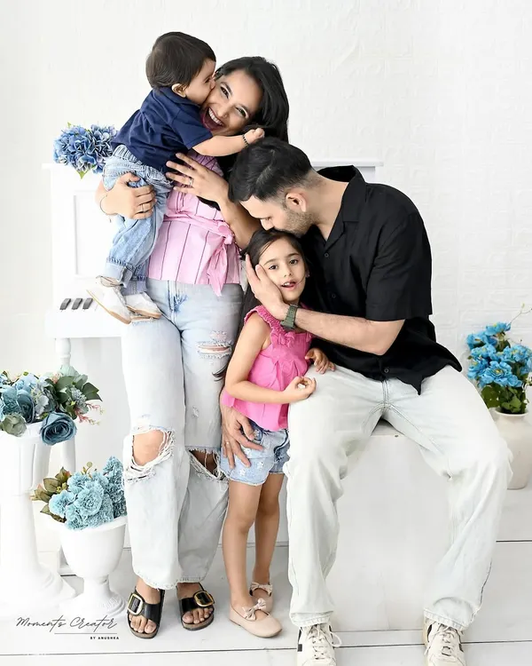 A candid moment of pure family love. The hugs, the kisses, the laughter, these are the unposed shots that truly tell your family's story during a milestone photoshoot.
