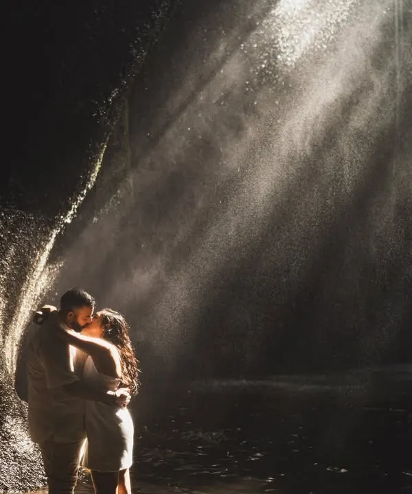 A breathtaking kiss in a secret waterfall, where sunbeams cut through the mist. This is the kind of magic we live to capture, a moment suspended in time, proving that the most epic love stories are found in nature's embrace.