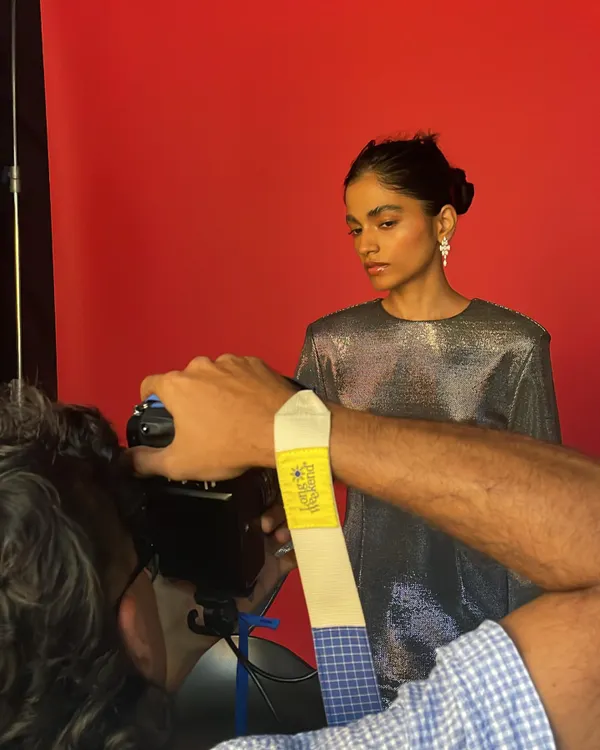 A behind-the-scenes moment from a jewelry shoot. This shows the collaboration between myself, the photographer, and the model to get the perfect shot against a vibrant red backdrop.