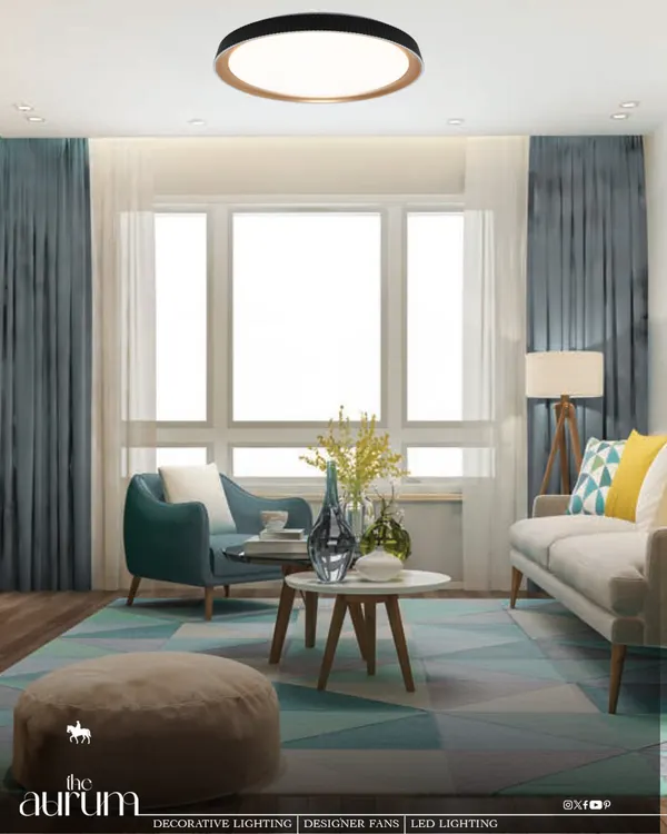 This modern living room features a sleek, circular LED ceiling light that provides clean, even illumination. The fixture's minimalist design complements the contemporary decor, transforming the architecture into a refined experience.