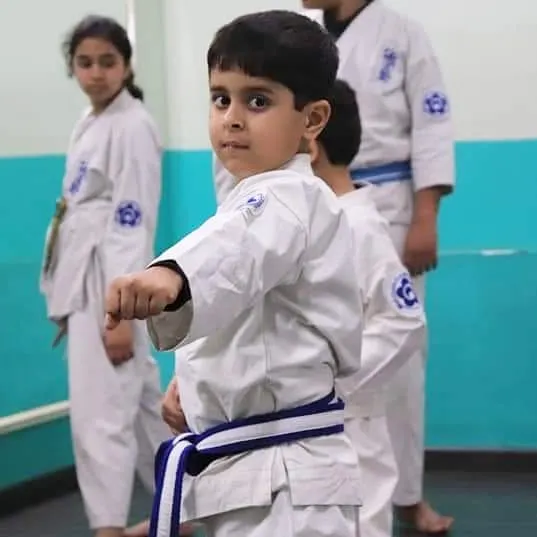 We teach our youngest students that true strength begins with focus. This young karateka demonstrates the concentration and discipline we instill in our kids' karate classes.