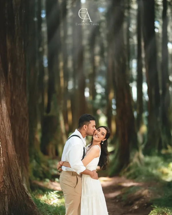 A sweet kiss on the cheek, filled with genuine laughter and affection. Capturing these spontaneous, happy moments is central to my approach, ensuring your pre-wedding photos reflect your true personalities.
