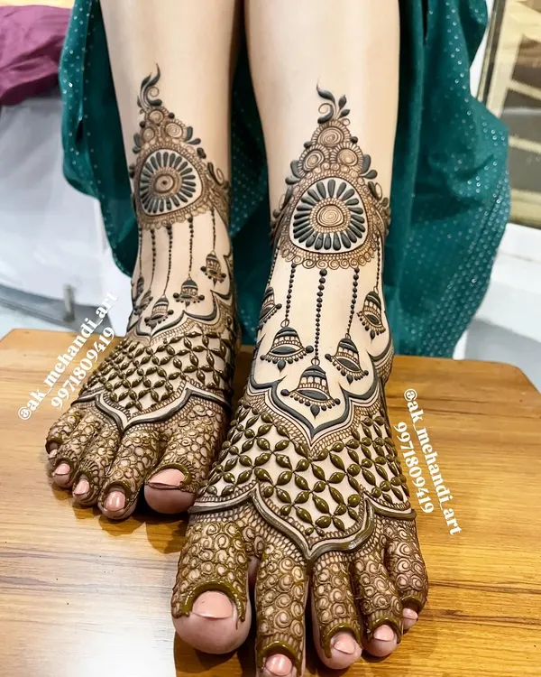 This is one of my most popular foot designs, featuring intricate patterns and hanging 'jhumka' (bell) motifs. It's designed to look like a beautiful piece of jewelry for your feet.