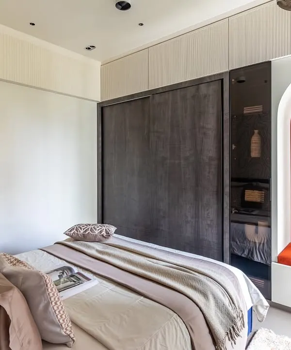 This kids' room is a world of wonder. The design includes a cozy bed, a playful reading nook in a vibrant orange arch, and a sleek wardrobe, creating a space where creativity knows no bounds.
