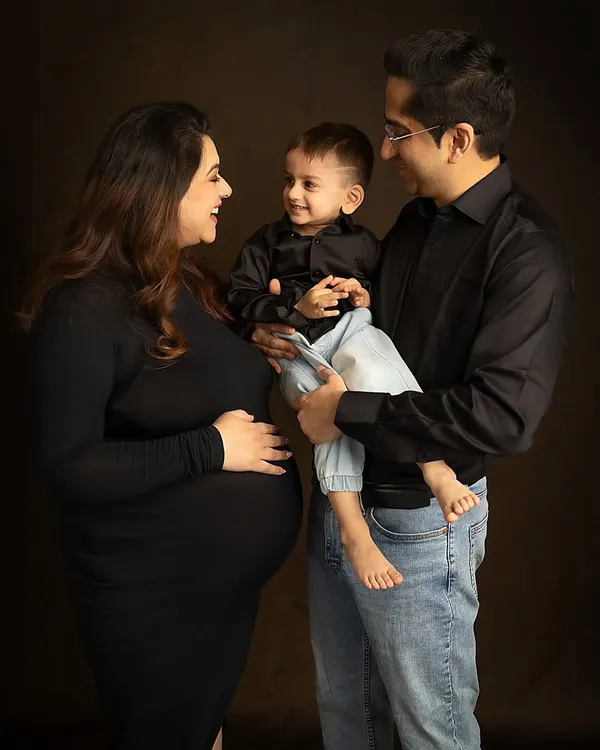 The pure joy of a family growing. This candid moment captures the laughter and love as they share their excitement with their firstborn. Family maternity sessions are a wonderful way to include everyone in the celebration.