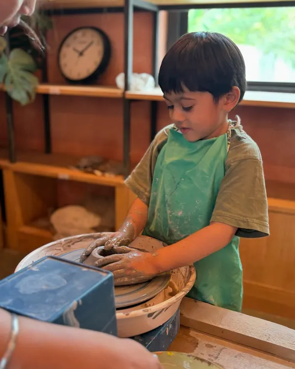 This is where the magic happens. I love seeing a child completely absorbed in the feeling of clay spinning on the wheel, creating something from their own imagination. It's a moment of pure focus and joy.