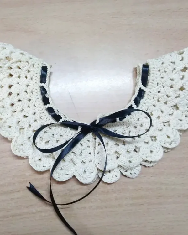 This is one of our detachable crochet collars, designed to look like angel wings. You can add it to any simple blouse or dress for a touch of vintage charm.