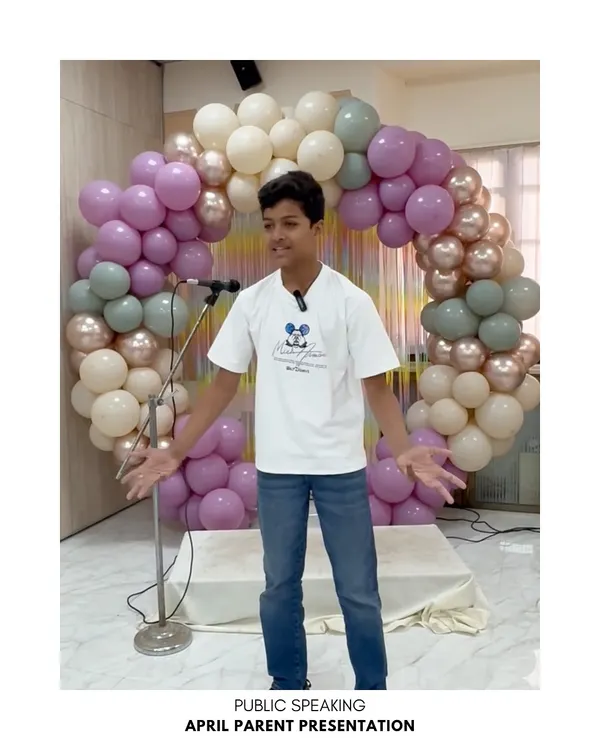 A student confidently delivers his speech during our public speaking presentation, using expressive gestures to engage the audience.