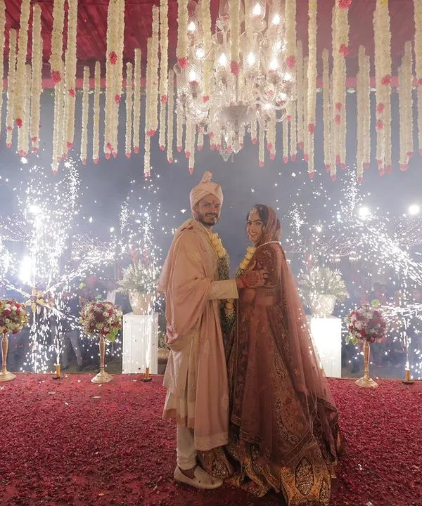 A picture of pure magic. I design spectacular moments like this, with the couple framed by cascading florals and a dazzling display of cold pyros, making the wedding ceremony feel like a scene from a movie.