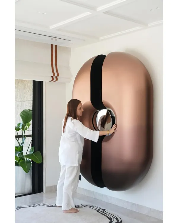Our viral statement bar unit is more than just furniture; it's a piece of kinetic sculpture. Located in the lounge of a Mumbai duplex, the pod-like structure slides open to reveal a fully stocked bar, complete with a mirrored counter. It’s a testament to innovative design and functional art.