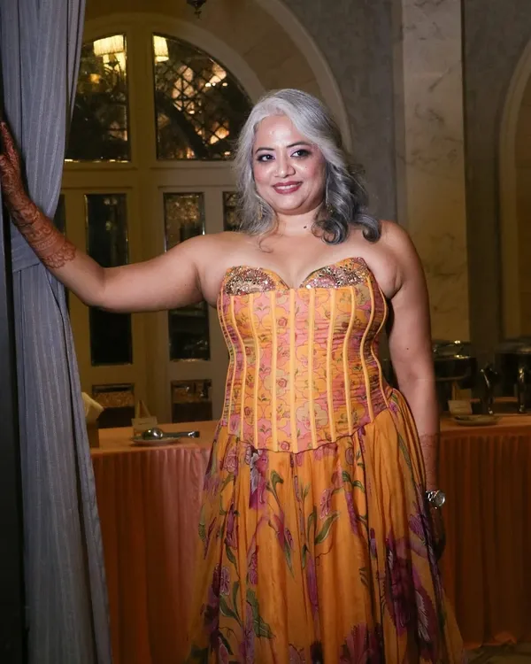The final look for a stunning bride's cocktail event. Her natural silver hair is styled into elegant waves, paired with makeup that makes her glow.