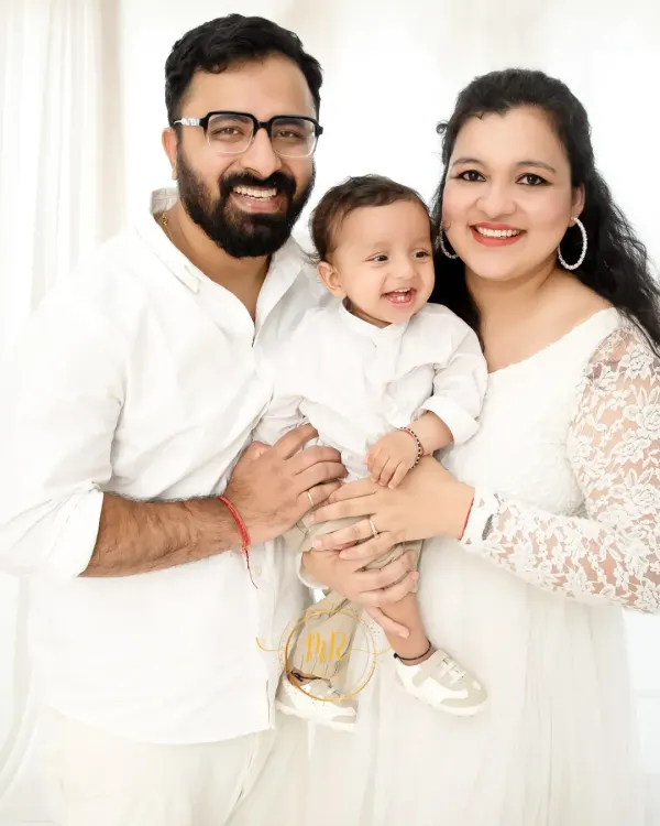 A classic family portrait taken in my Gurugram studio. I used a clean, white backdrop and bright lighting to create this timeless, light, and airy look that puts the family's happy connection front and center.