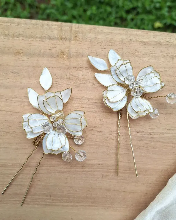 Our delicate, handcrafted floral hair pins are perfect for a bridal look or any special occasion. Each petal is lovingly shaped and adorned with shimmering crystals for a subtle, romantic sparkle.