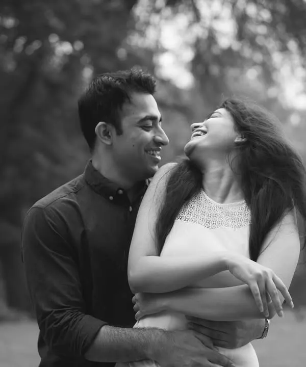 A black and white photo capturing a moment of pure, uninhibited laughter. These are the moments I live for, the ones that show the true heart of a relationship.