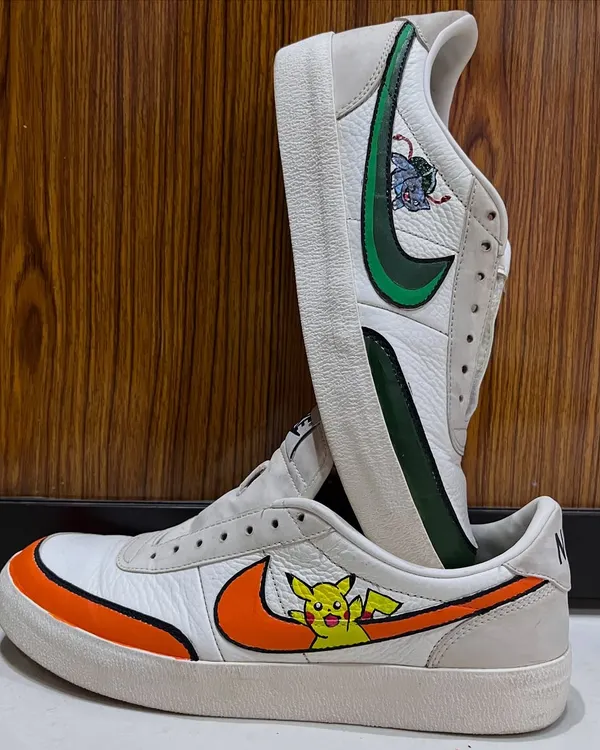 A pair of classic Nike sneakers transformed into wearable art. I hand-painted these with a custom Pokémon theme, featuring Pikachu on one shoe and Bulbasaur on the other, each integrated with the iconic swoosh.