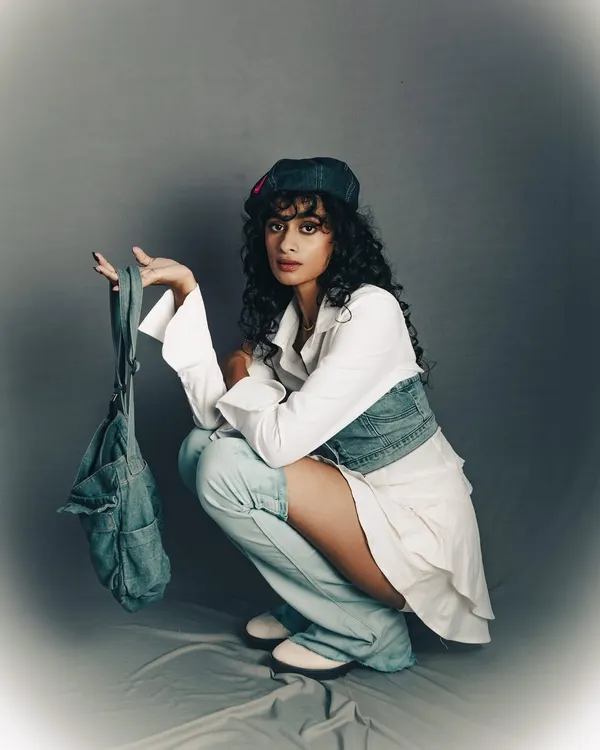 A cool, urban-inspired studio shoot. The simple grey background puts all the focus on the model's attitude and the layered denim styling.