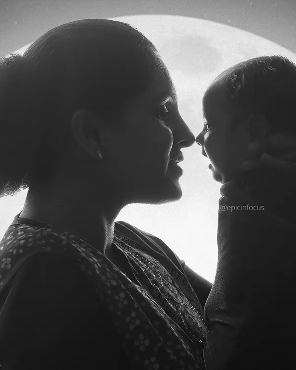 A powerful silhouette of a mother and her newborn, capturing the profound bond in a simple, artistic way. These intimate moments are a beautiful part of our family sessions.