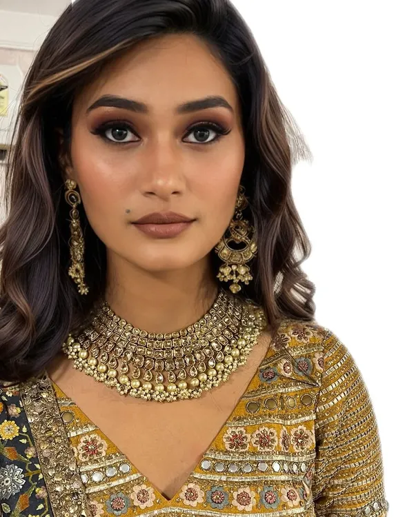 This is my signature modern glam look. I focus on creating a flawless, soft-focus complexion, sculpted features, and gilded eyelids that look stunning both in person and on camera.