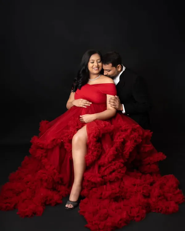 This is what dreams are made of! I love creating these bold, glamorous portraits for moms-to-be. This stunning red gown is part of my client closet, and we used a simple black backdrop in the studio to make the color and the beautiful baby bump truly pop.