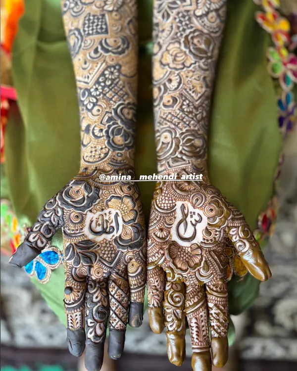 This design features the couple's initials hidden in the palms. It's a beautiful way to add a personal touch to your bridal mehendi.