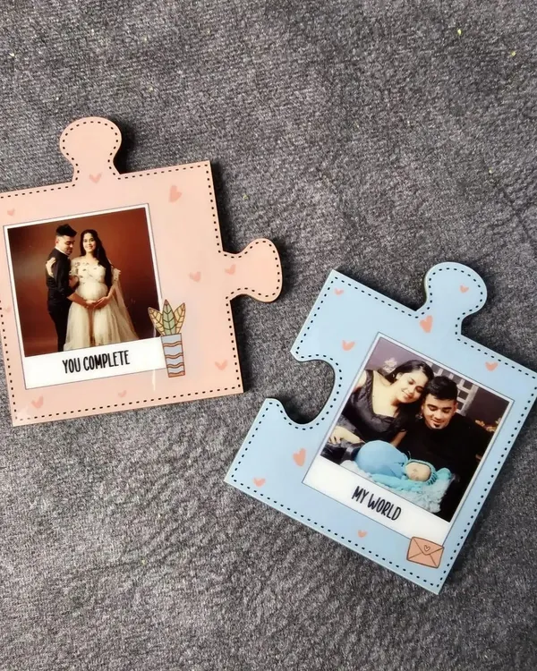These interlocking puzzle piece magnets are a sweet gift for couples. One piece says 'You Complete Me' and the other says 'My World', each holding a special photo.