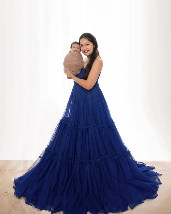 A mother's love, captured in a single, elegant frame. Here, a new mom holds her swaddled baby, creating a portrait of pure grace and connection that she will treasure for a lifetime.