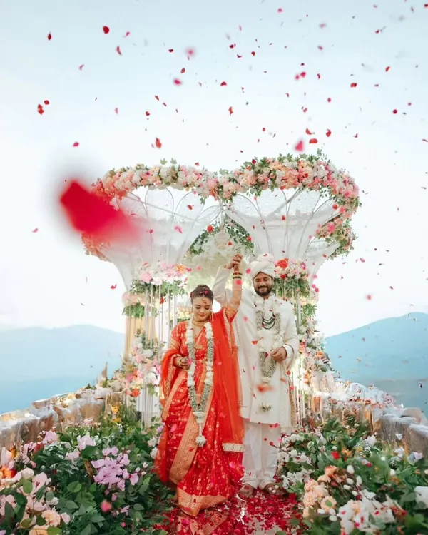 A shower of rose petals marks the beginning of a new journey. We believe in capturing the grand moments with as much intimacy as the quiet ones, creating a perfect memory of joy and celebration against a stunning mountain backdrop.