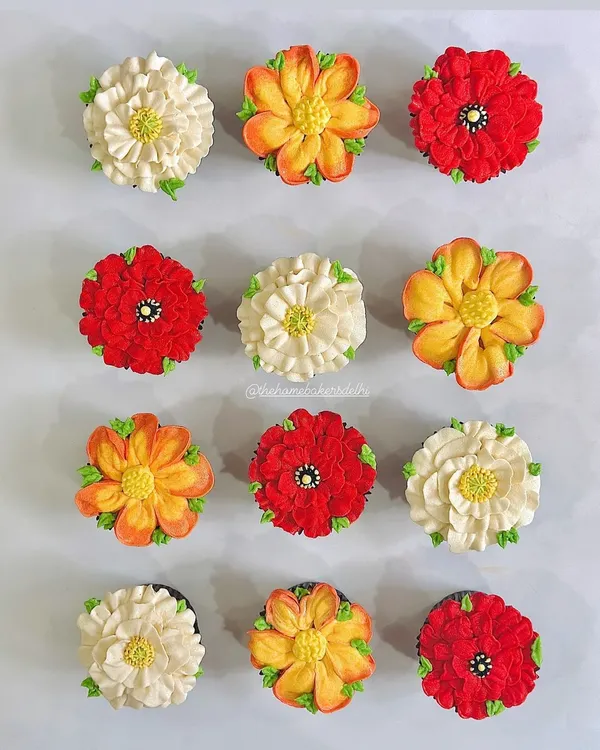 This is our buttercream artwork in full bloom. We hand-pipe every petal to create these vibrant, edible flowers. This box features a mix of our most requested floral designs, showing the variety of colors and styles we can craft for your custom cupcake order.