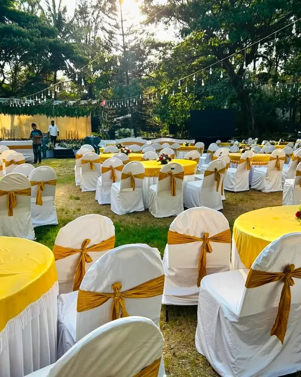 I can manage decorations for large scale outdoor corporate events. Here is a complete seating arrangement with custom chair covers, tablecloths, and floral centerpieces, ready for guests.